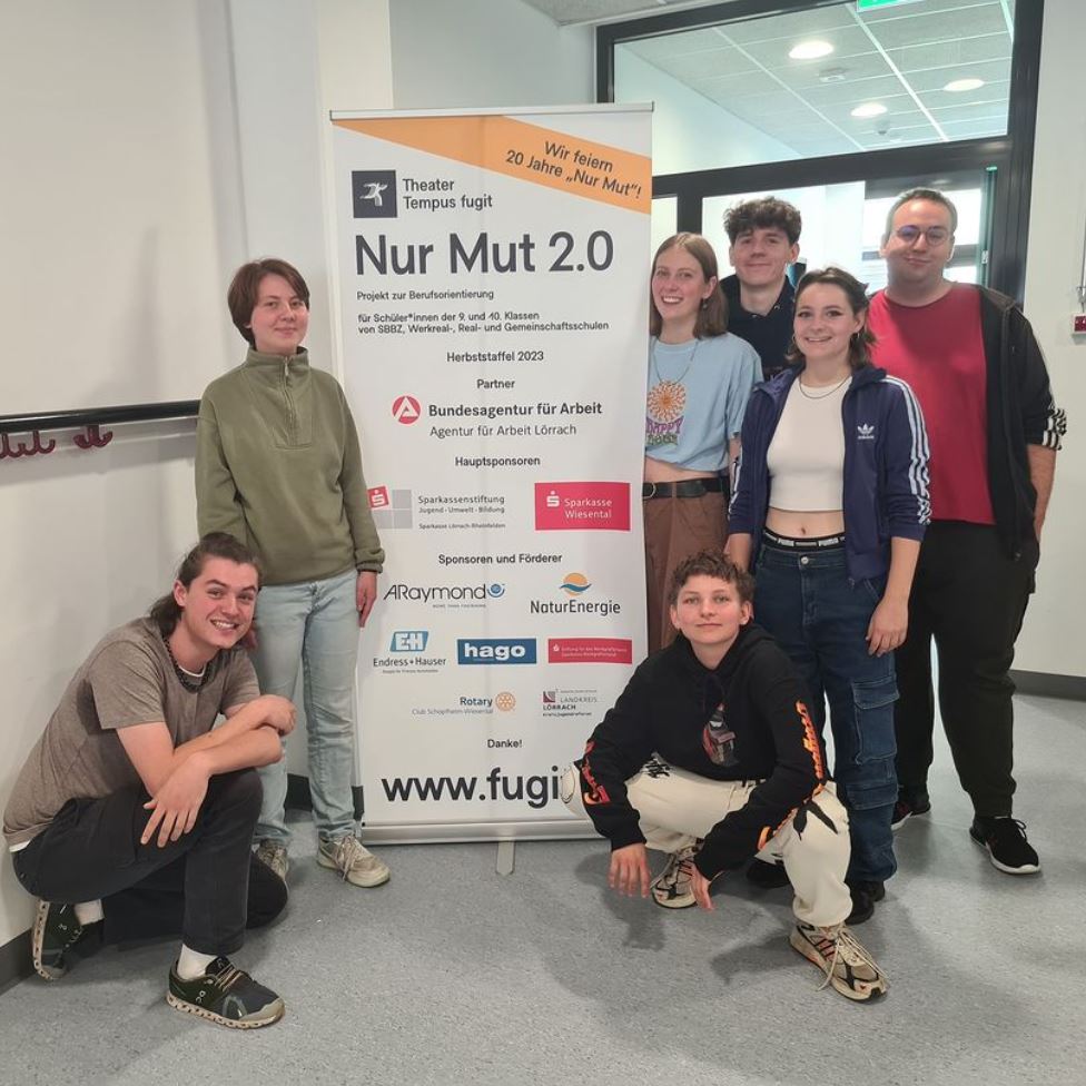 People standing next to a rollup